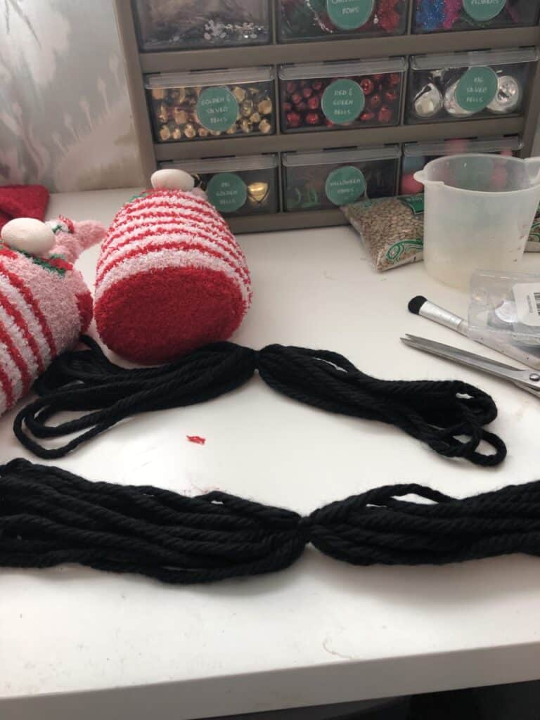 Step 1:  Measure your yarn form the nose to the bottom, double the measurement, and cut several pieces.