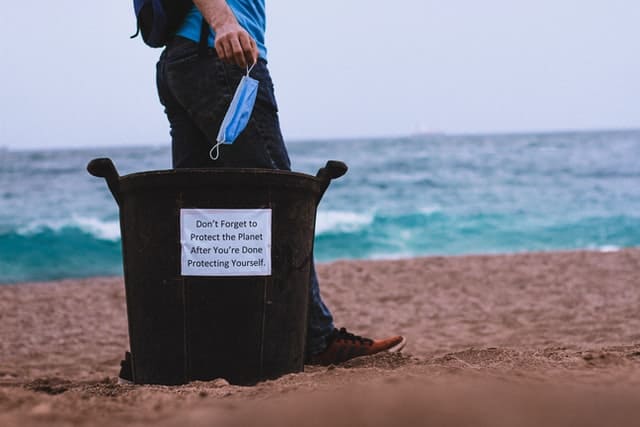Using a trash can at the beach - photo by Dhaya Eddine Bentaleb from Unsplash
