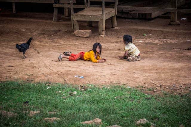 Children laying in mud by Suraphat from Pexels