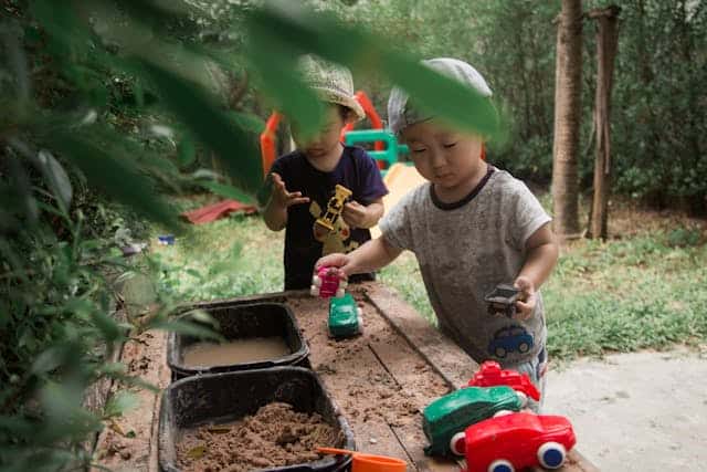 Children playing in the mud and water table by Micah Ways from Pexels